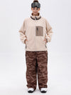 Pantalon de ski ample et fluide pour femme, en polaire sherpa synthétique zippée et genoux renforcés.