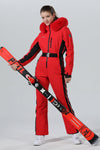Combinaison de ski une pièce chic à capuche en fourrure pour femme, haute performance.