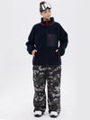 Pantalon de ski ample et fluide pour femme, en polaire sherpa synthétique zippée et genoux renforcés.