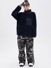 Pantalon de ski ample et fluide pour femme, en polaire sherpa synthétique zippée et genoux renforcés.