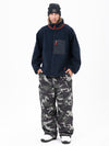 Pantalon de ski ample et zippé en polaire sherpa synthétique pour homme, avec genoux renforcés.