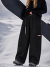 Pantalon de snowboard cargo ample et extensible pour femme, style freestyle, en tissu Techline utilitaire et résistant.